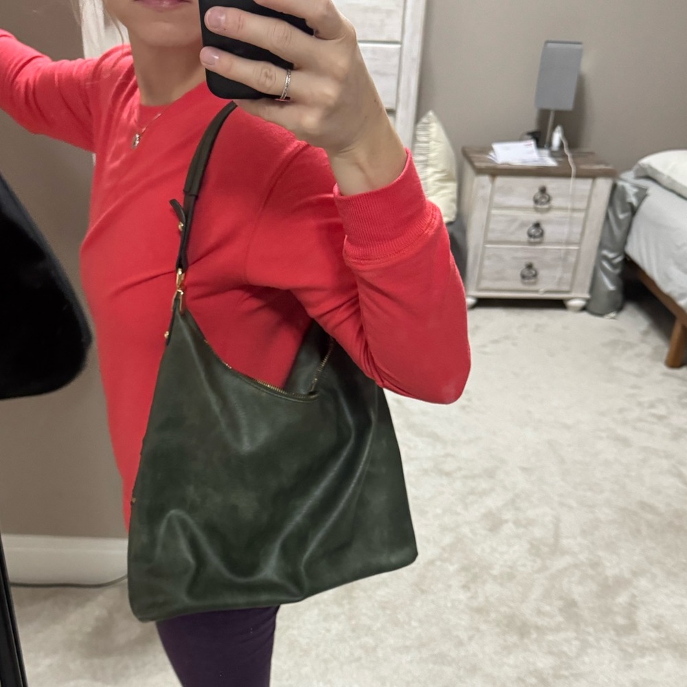 Olive green faux leather hobo bag with tassels and gold details.